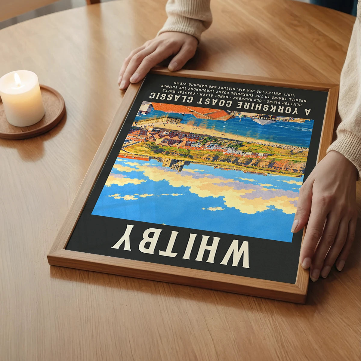 Vintage seaside Whitby print on a bedroom wall, portrait format with sunny coastal scene
