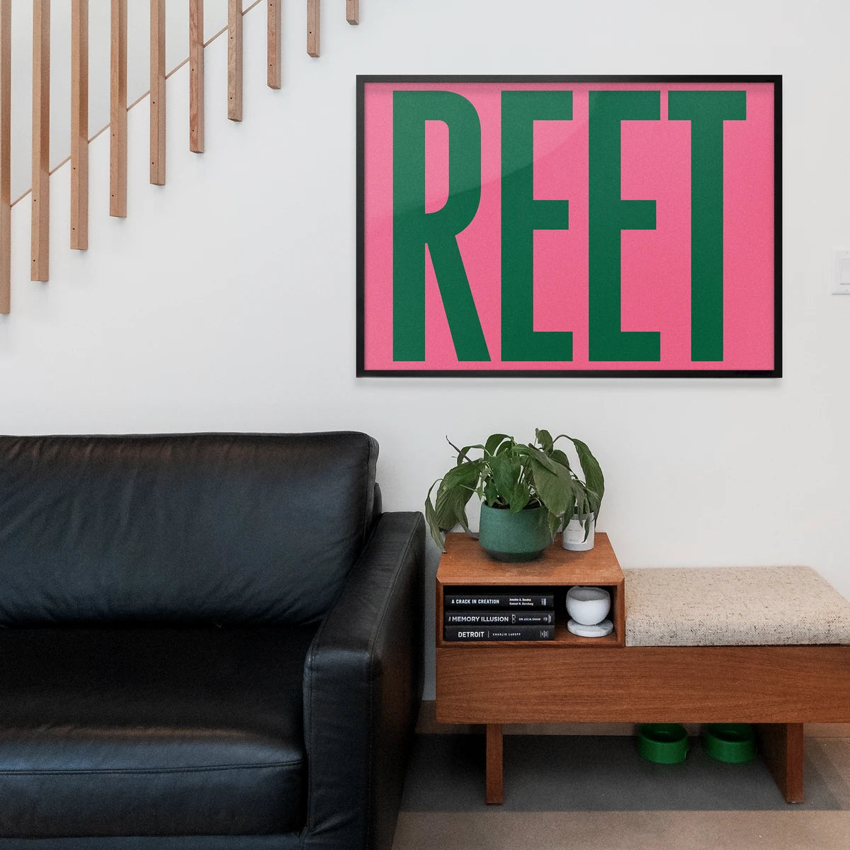Bold green reet typography framed above a home office desk