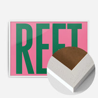 bold green reet typography print in a white wood frame, side profile
