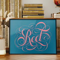 Reet typography print in swirly pink calligraphy displayed on a living room wall