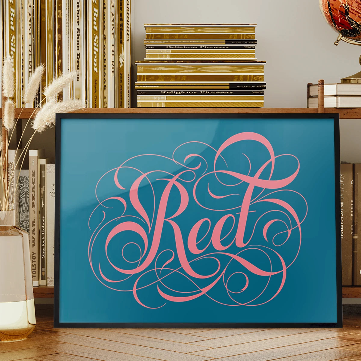 Reet typography print in swirly pink calligraphy displayed on a living room wall