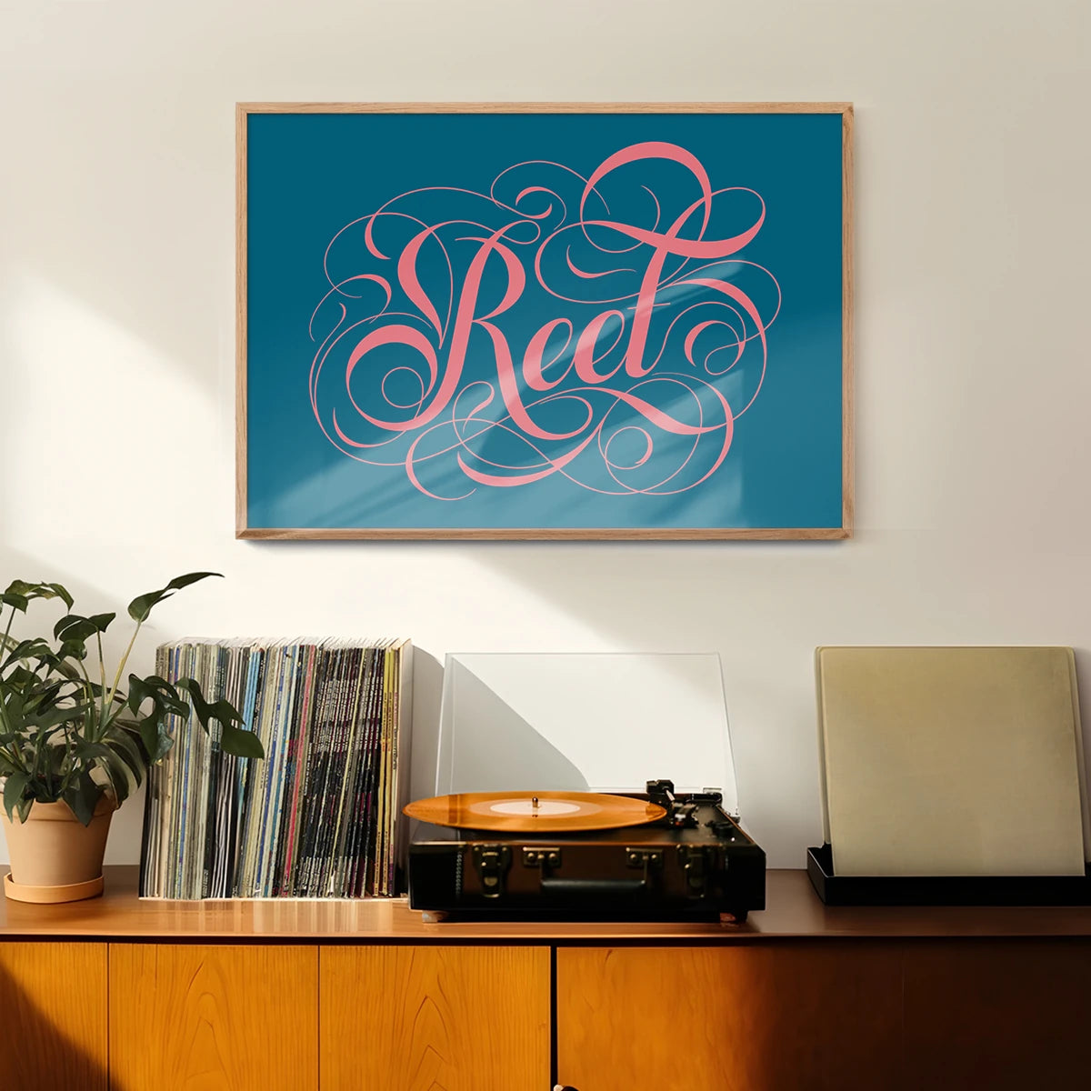 Swirly calligraphy lettering print hung in a welcoming hallway