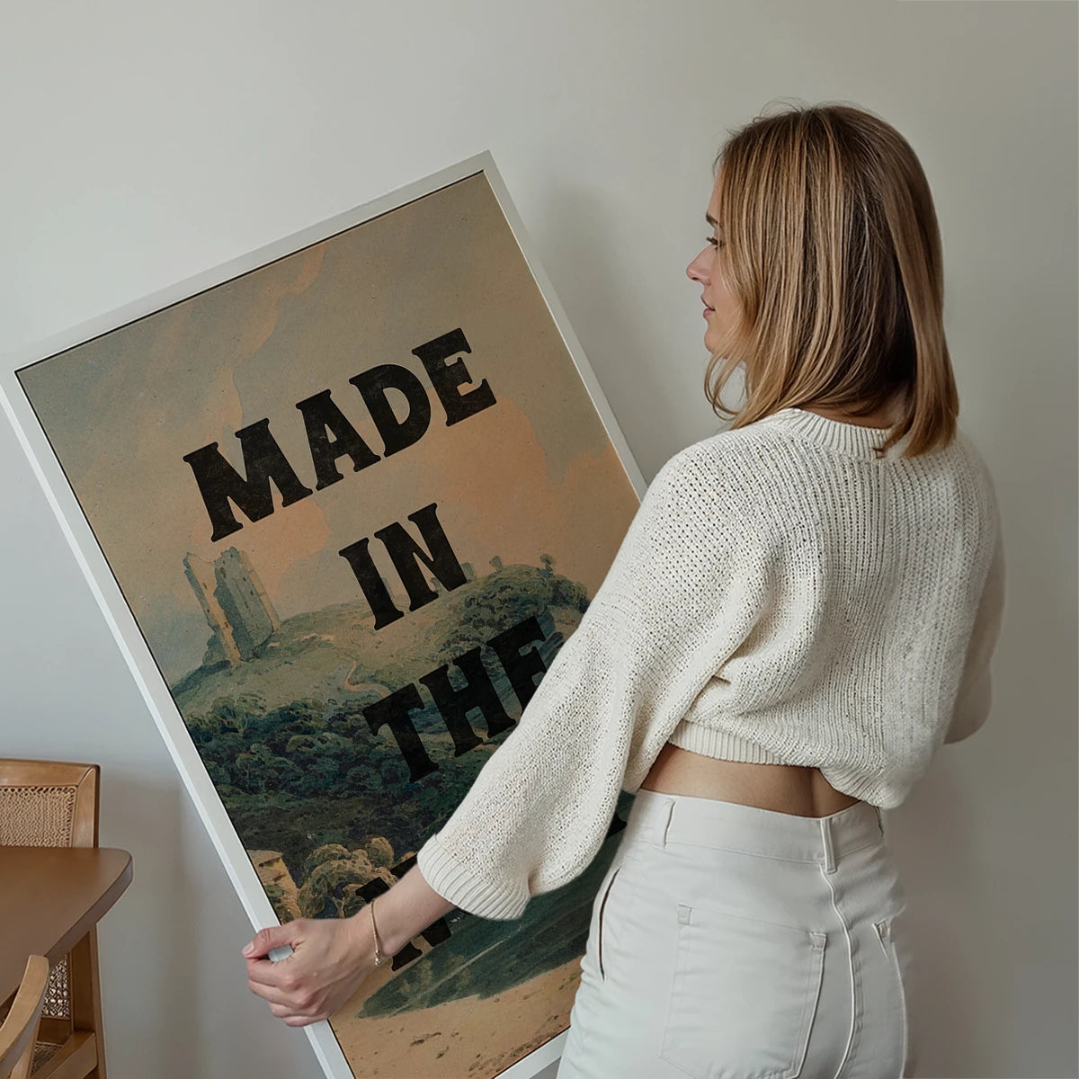 Made in the North print displayed on a living room wall, typography over a castle ruin landscape