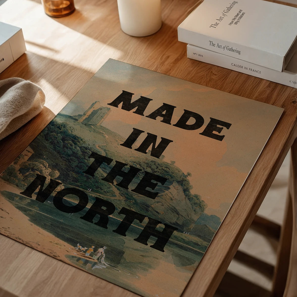 The print in a dining room, bold black lettering over a muted vintage landscape