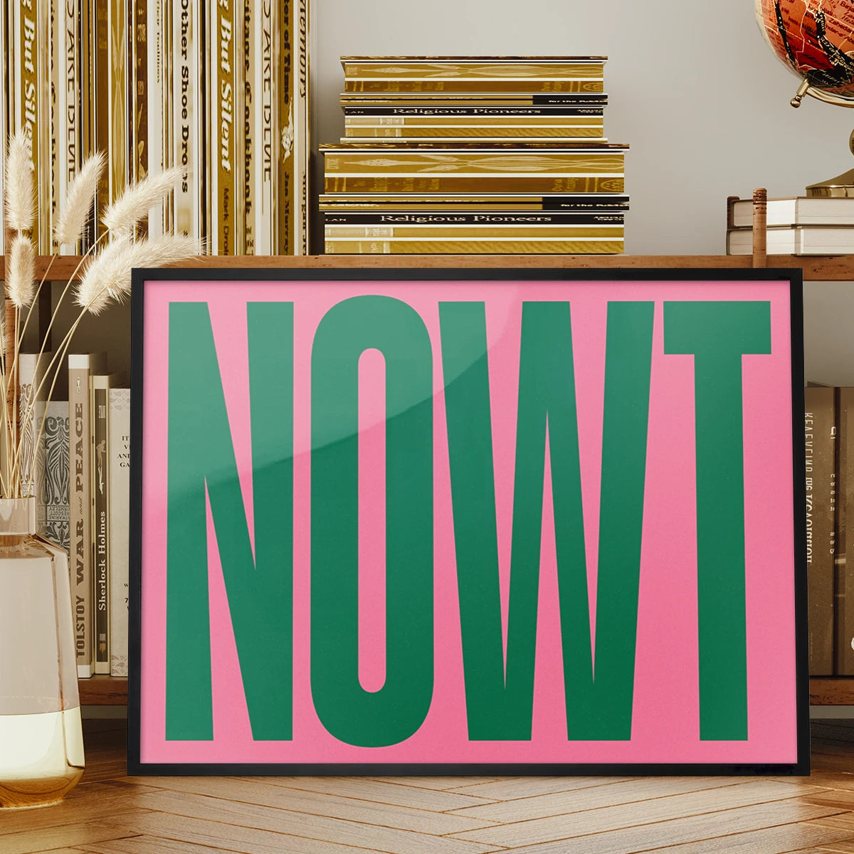 Nowt typography print in bold green on pink displayed on a living room wall