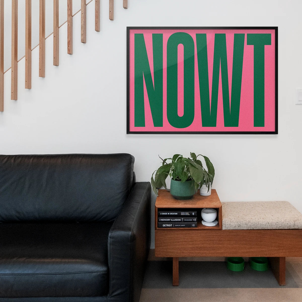 Bold green and pink typography wall art in a home office