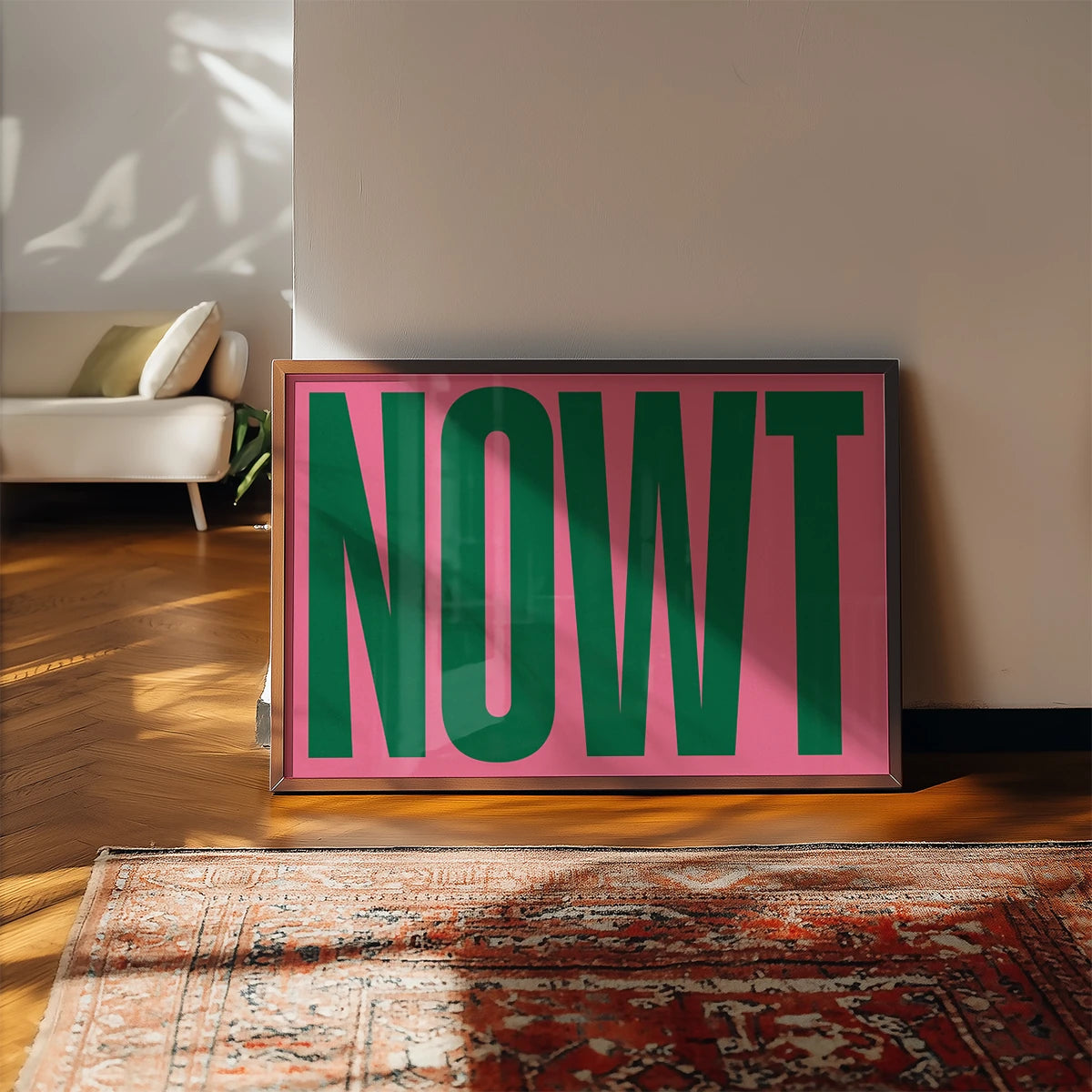 The print in dark green and pink lettering displayed in a kitchen