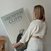 Bempton Cliffs puffin print displayed on a living room wall