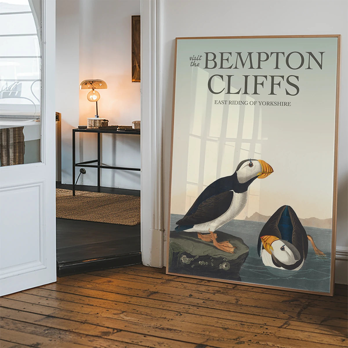 Vintage puffins on coastal rock print hung in a hallway