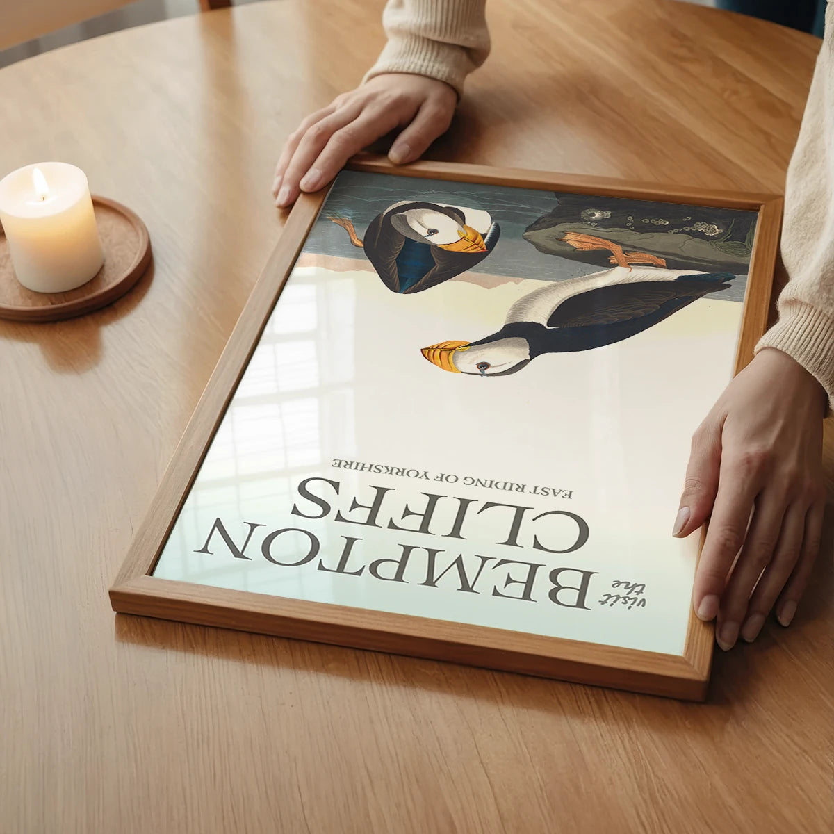 The print of two illustrated puffins in a calm bedroom setting