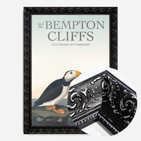 vintage puffins on coastal rock print in a black ornate frame, side profile