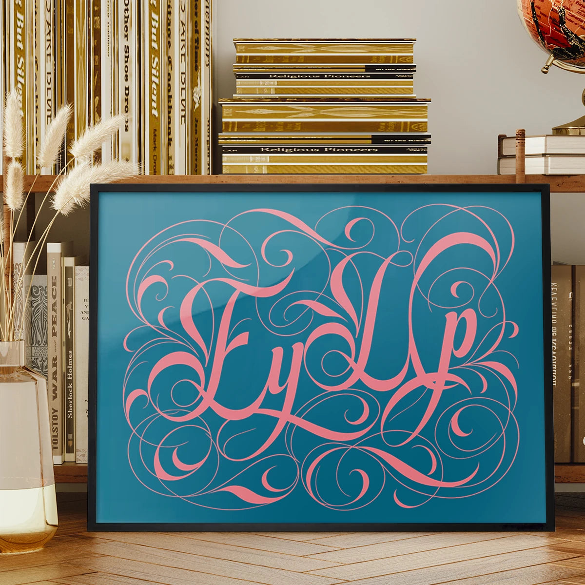 Ey Up typography print in pink calligraphy displayed on a living room wall