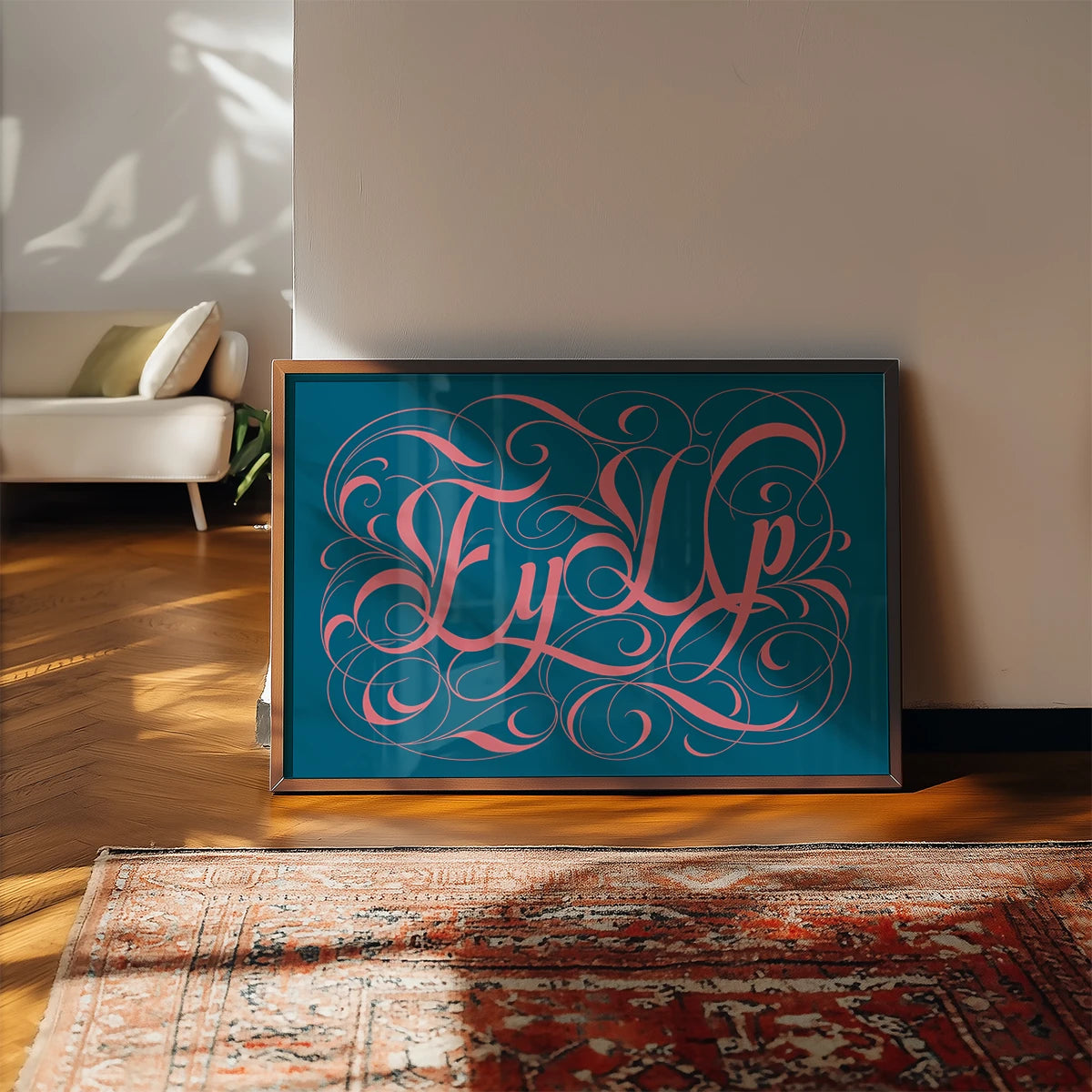 Ornate calligraphy lettering print in coral and teal on a kitchen wall