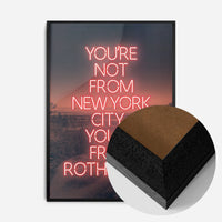 red neon Rotherham typography print in a black wood frame, side profile
