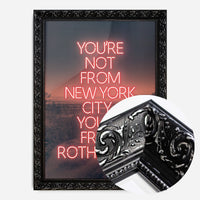 red neon Rotherham typography print in a black ornate frame, side profile