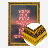 red neon Rotherham typography print in a gold ornate frame, side profile