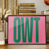 Owt typography print in a landscape frame displayed above a sofa in a living room