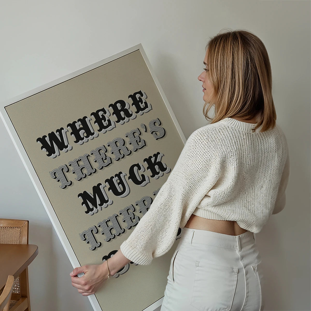 Where There's Muck There's Brass print displayed on a living room wall as bold typography wall art