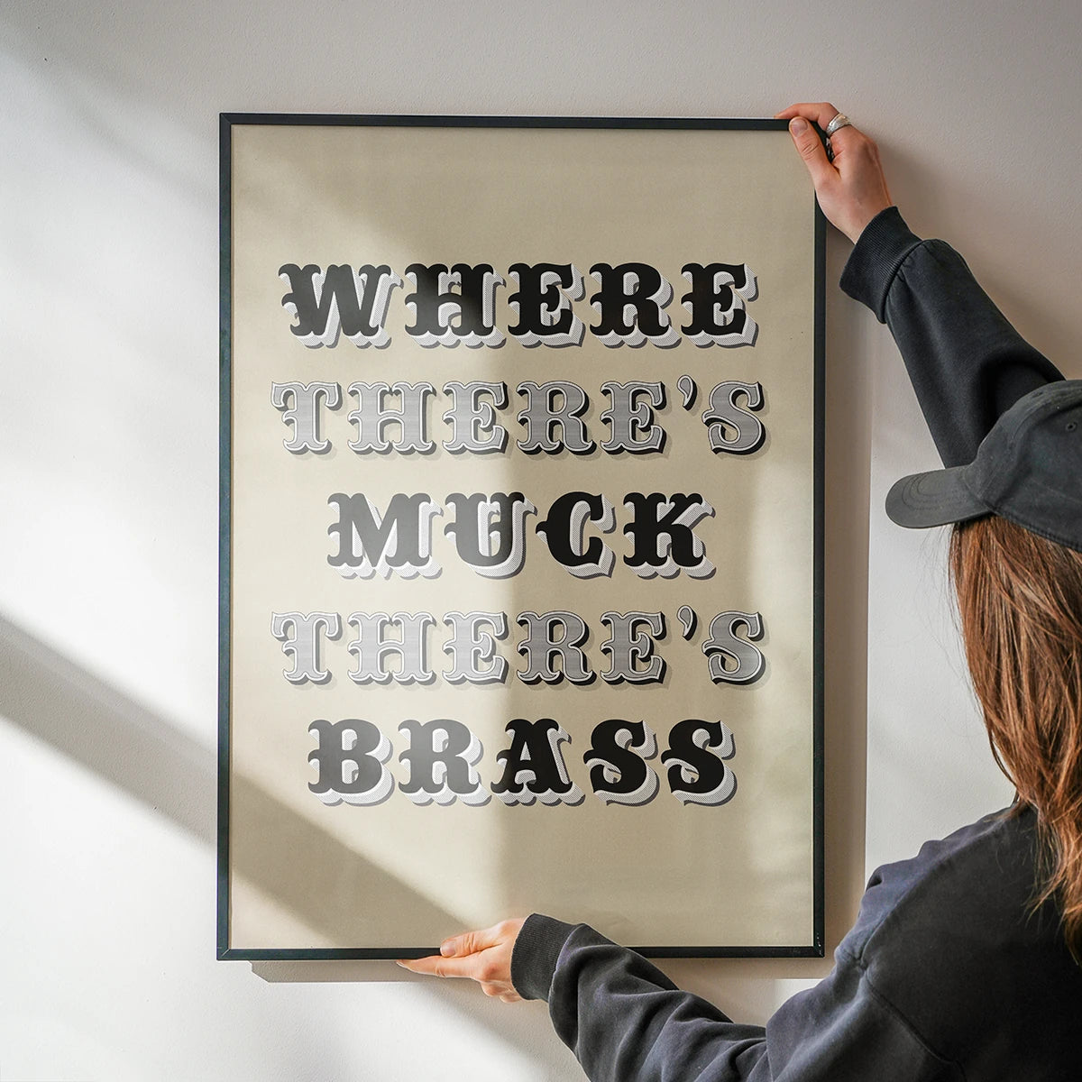 Where There's Muck There's Brass print in a kitchen, vintage-style lettering as wall decor