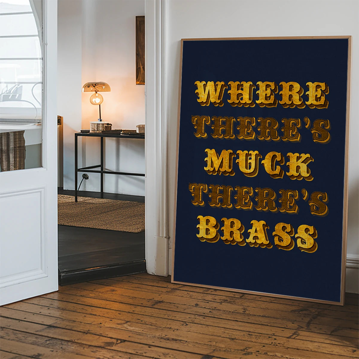 Golden typography quote print displayed in a hallway