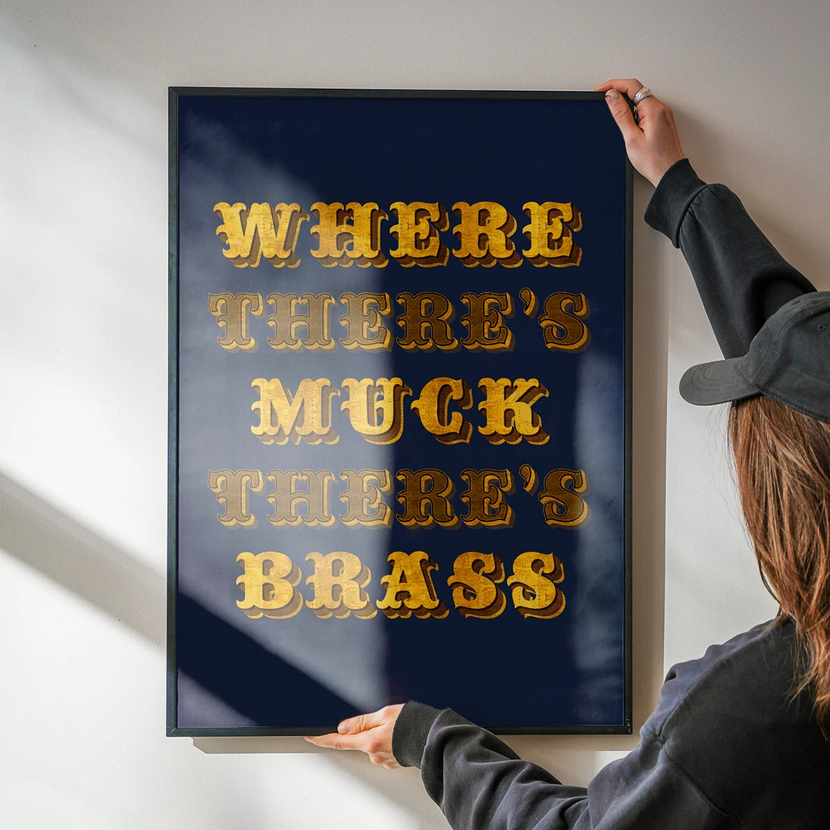 Golden typography quote art hung in a kitchen