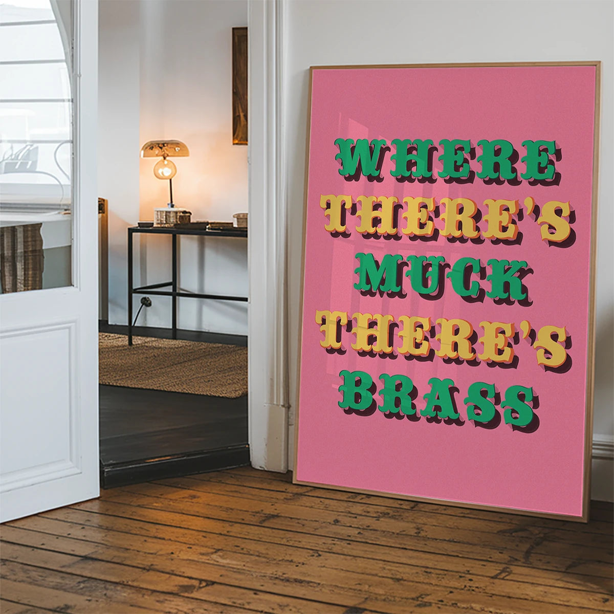 Pink typography print displayed in a hallway as a colourful statement piece