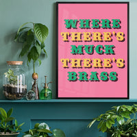 Bold typography print above a desk in a home office, green and yellow lettering on pink