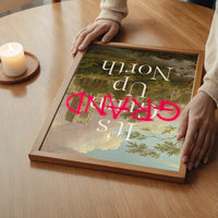 The print with pink graffiti lettering over an abbey landscape in a bedroom