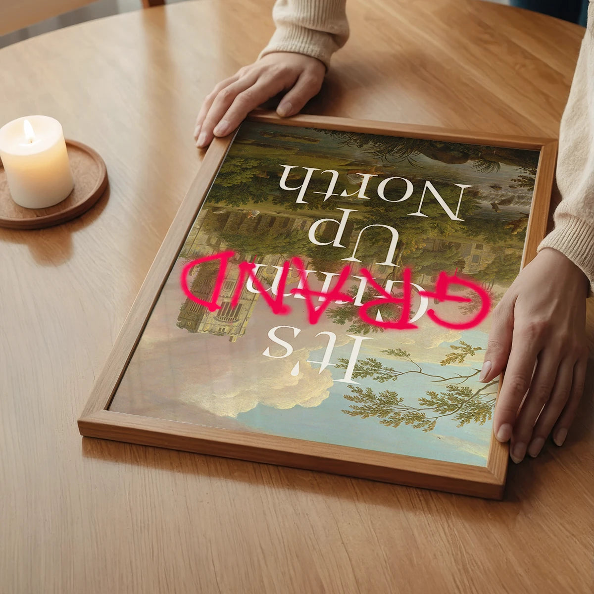 The print with pink graffiti lettering over an abbey landscape in a bedroom
