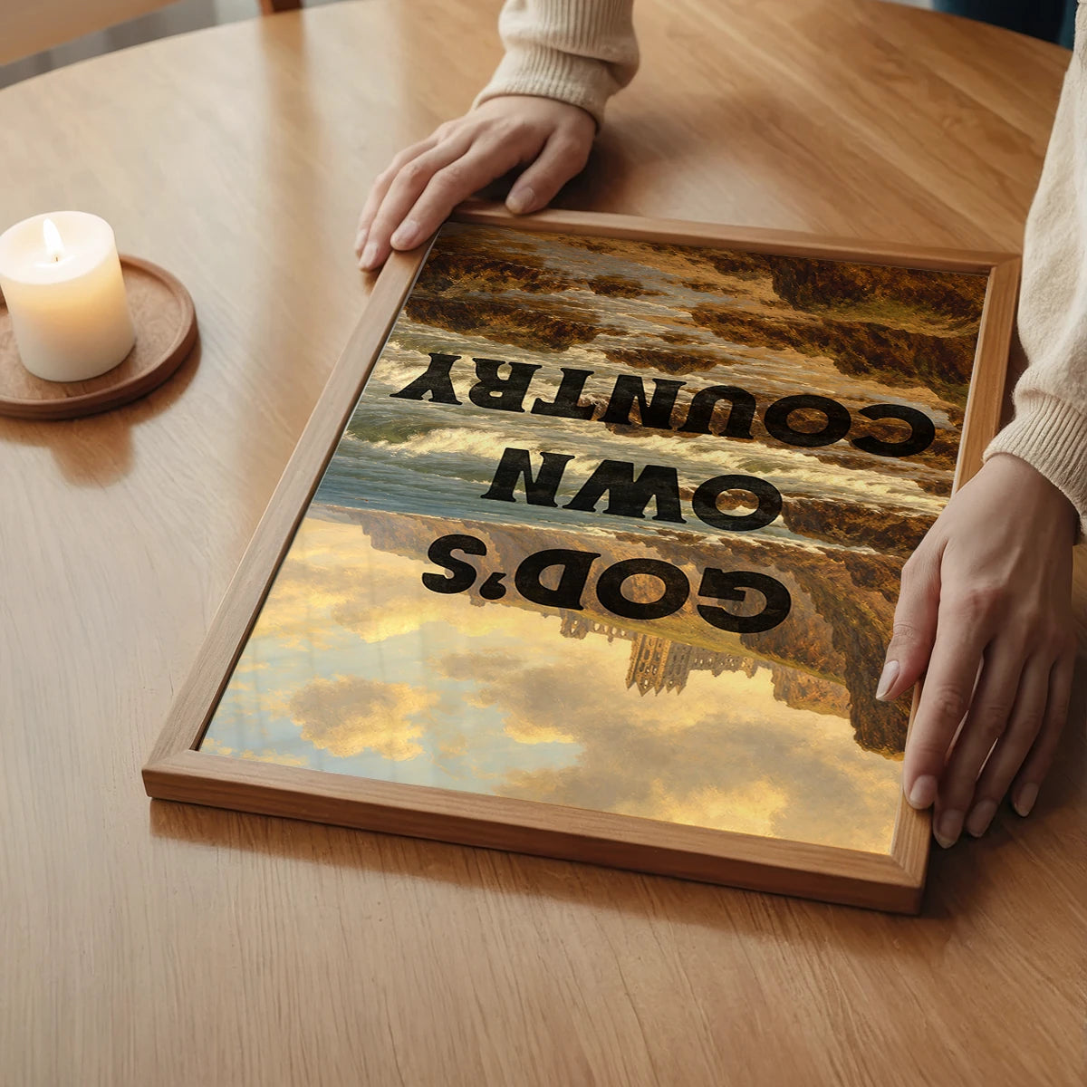 The print showing a coastal abbey scene with bold lettering in a bedroom